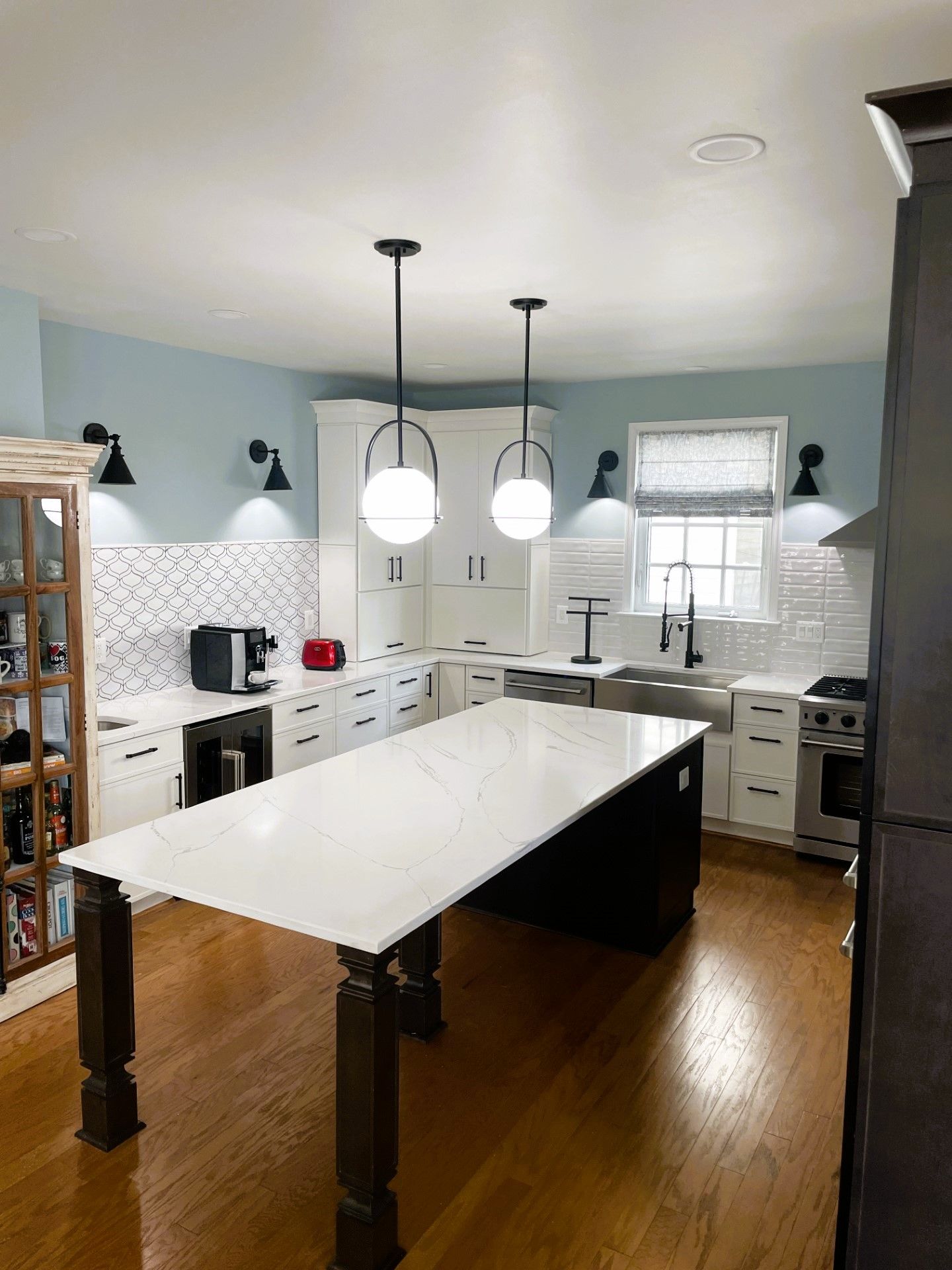 A kitchen with a large table in the middle of it.