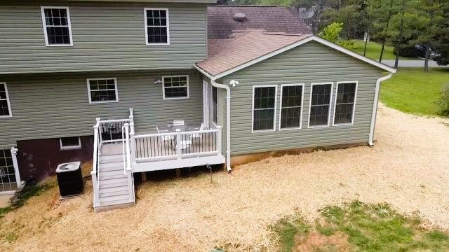 An aerial view of a house with a large deck.