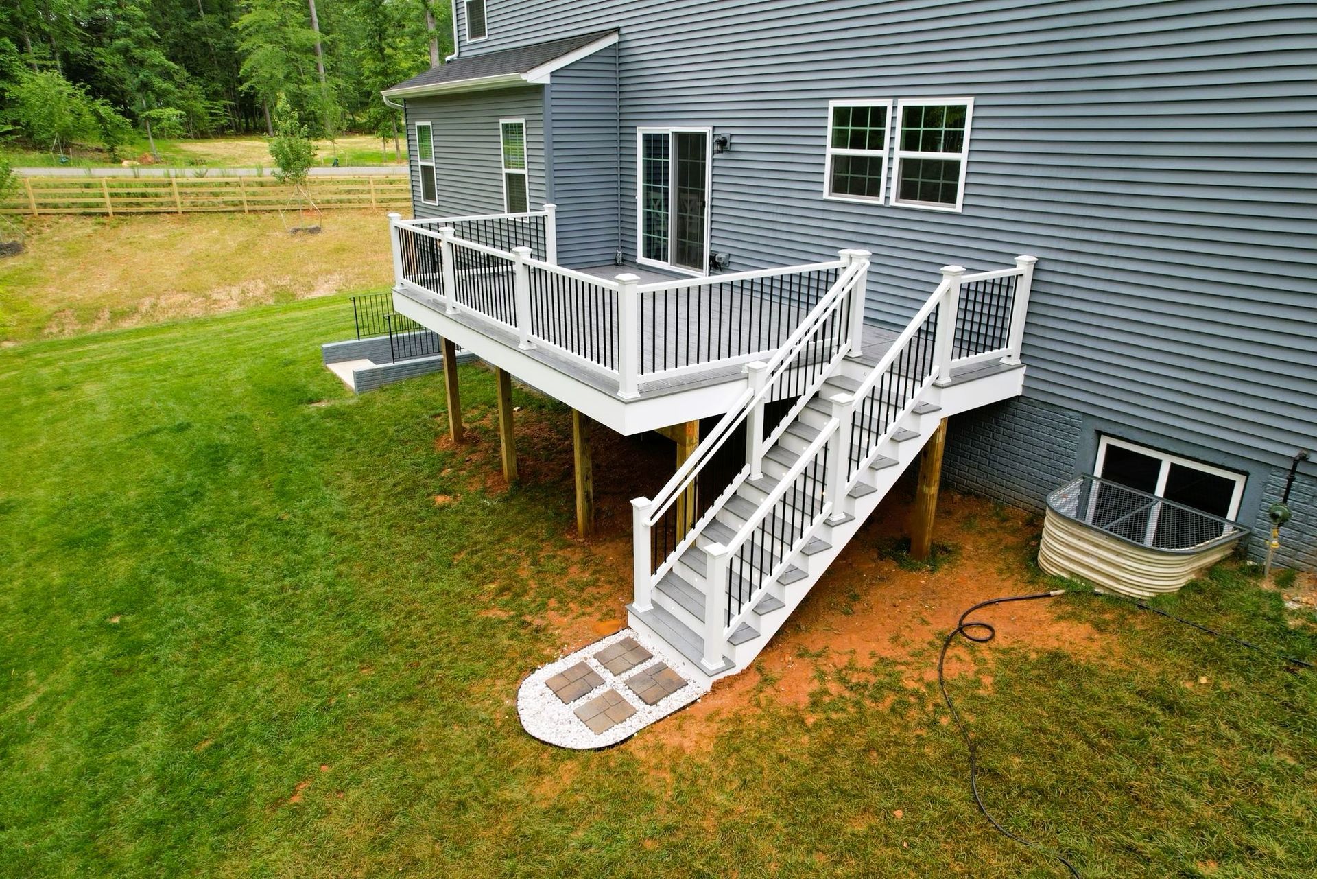 An aerial view of a house with a deck and stairs.