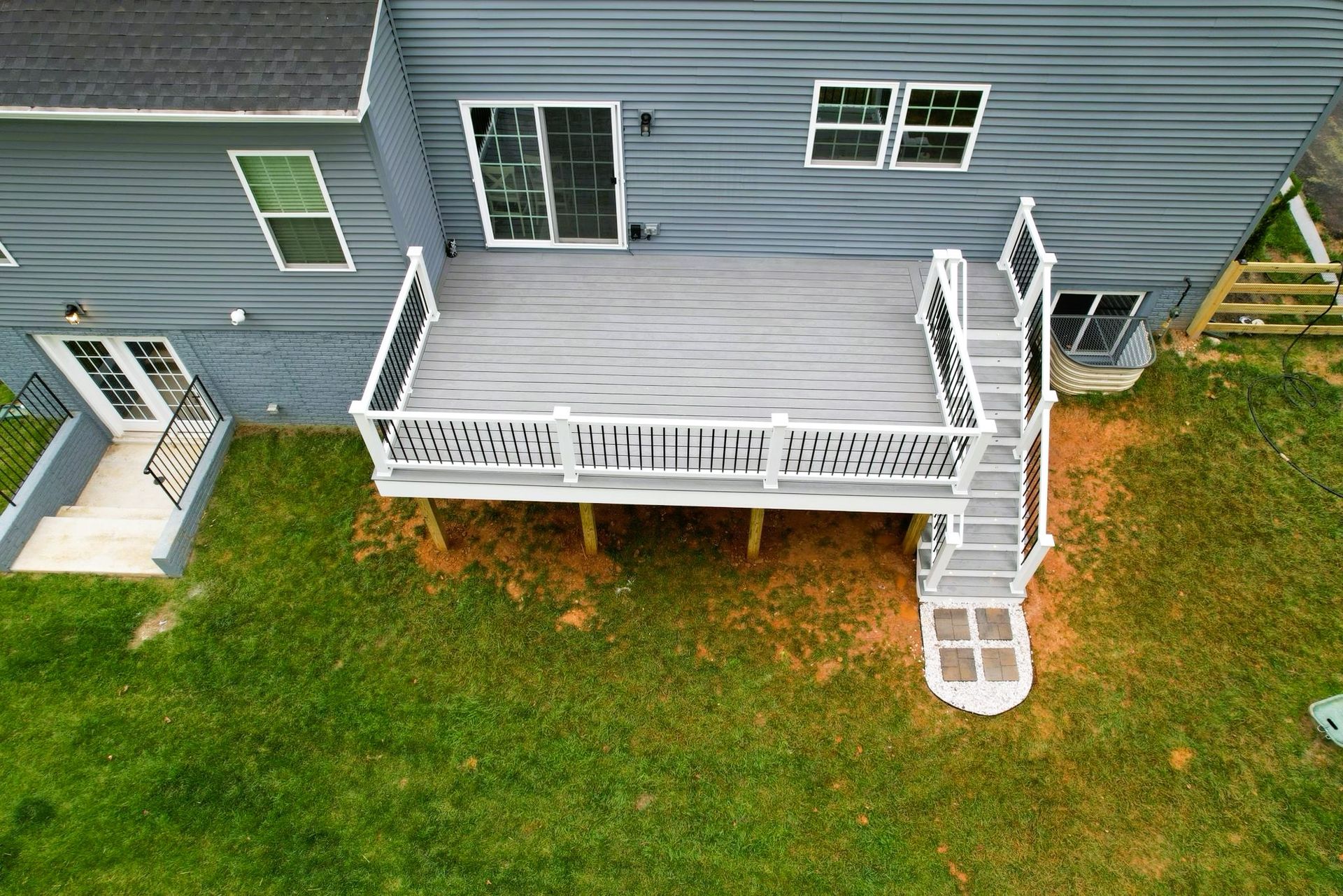 An aerial view of a large deck in front of a house.