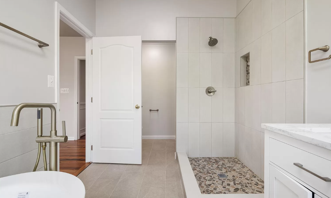 A bathroom with a walk in shower , sink , toilet and bathtub.