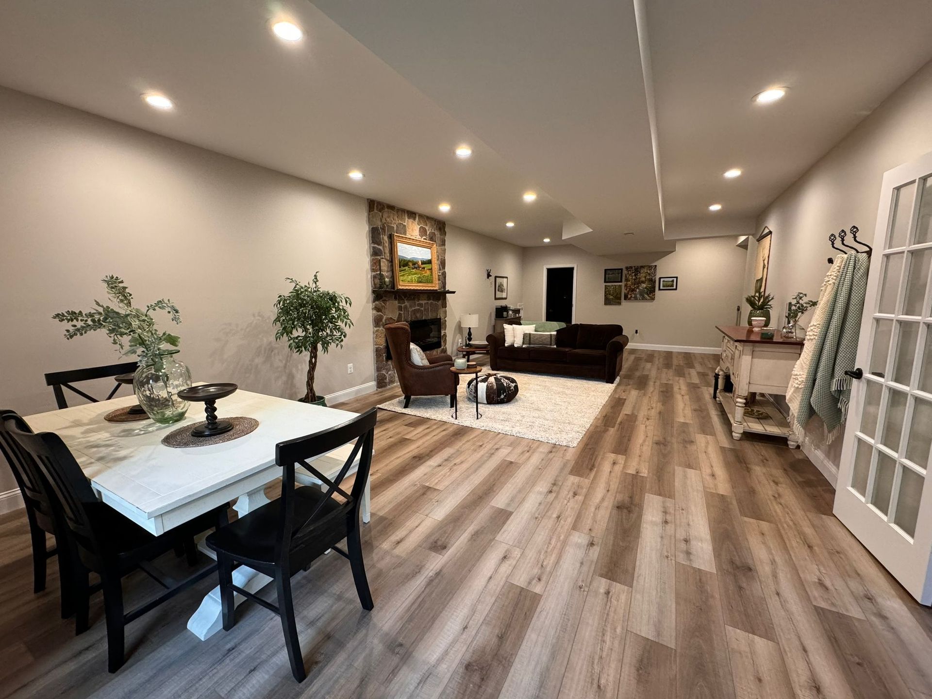 A living room with a table and chairs and a fireplace.