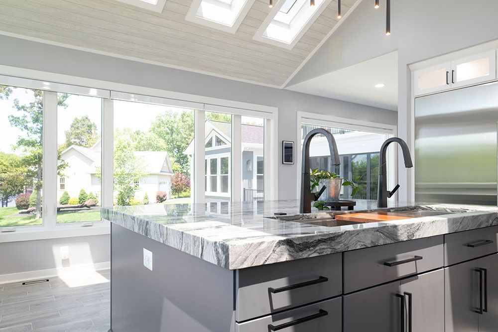 A kitchen with a large island and a sink