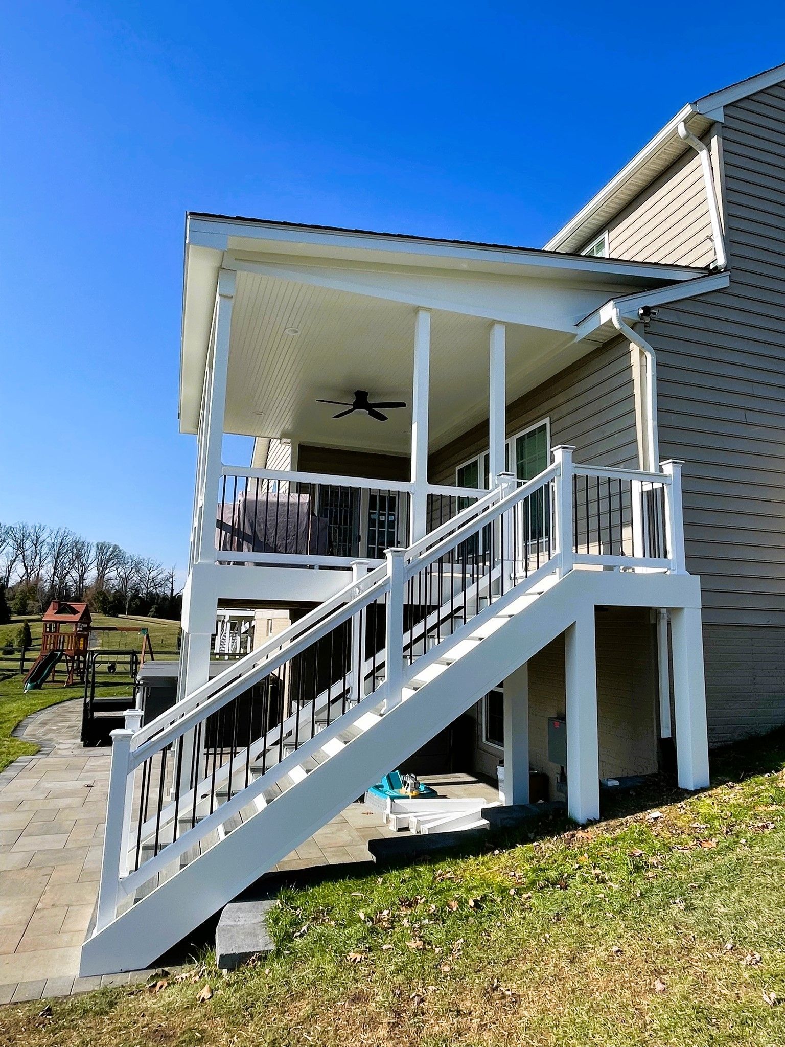 A house with a porch and stairs leading up to it.