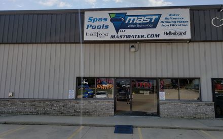 A building with a sign that says mast on it