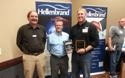 Three men standing in front of a banner that says hellenbrand