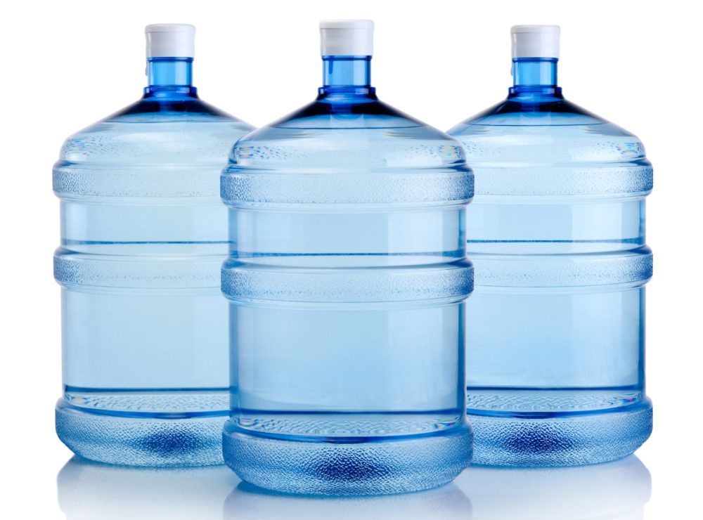 Three bottles of water are sitting next to each other on a white background.