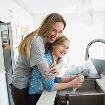 A water filter is sitting on a kitchen counter next to a sink.