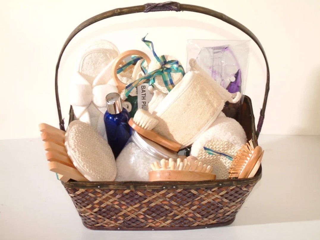 Basket filled with bath products, including brushes, sponges, and bottles.