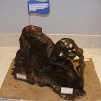 Child sculpture of human figure climbing rocks