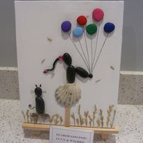 3D sculpture of girl holding balloons with shell as the skirt