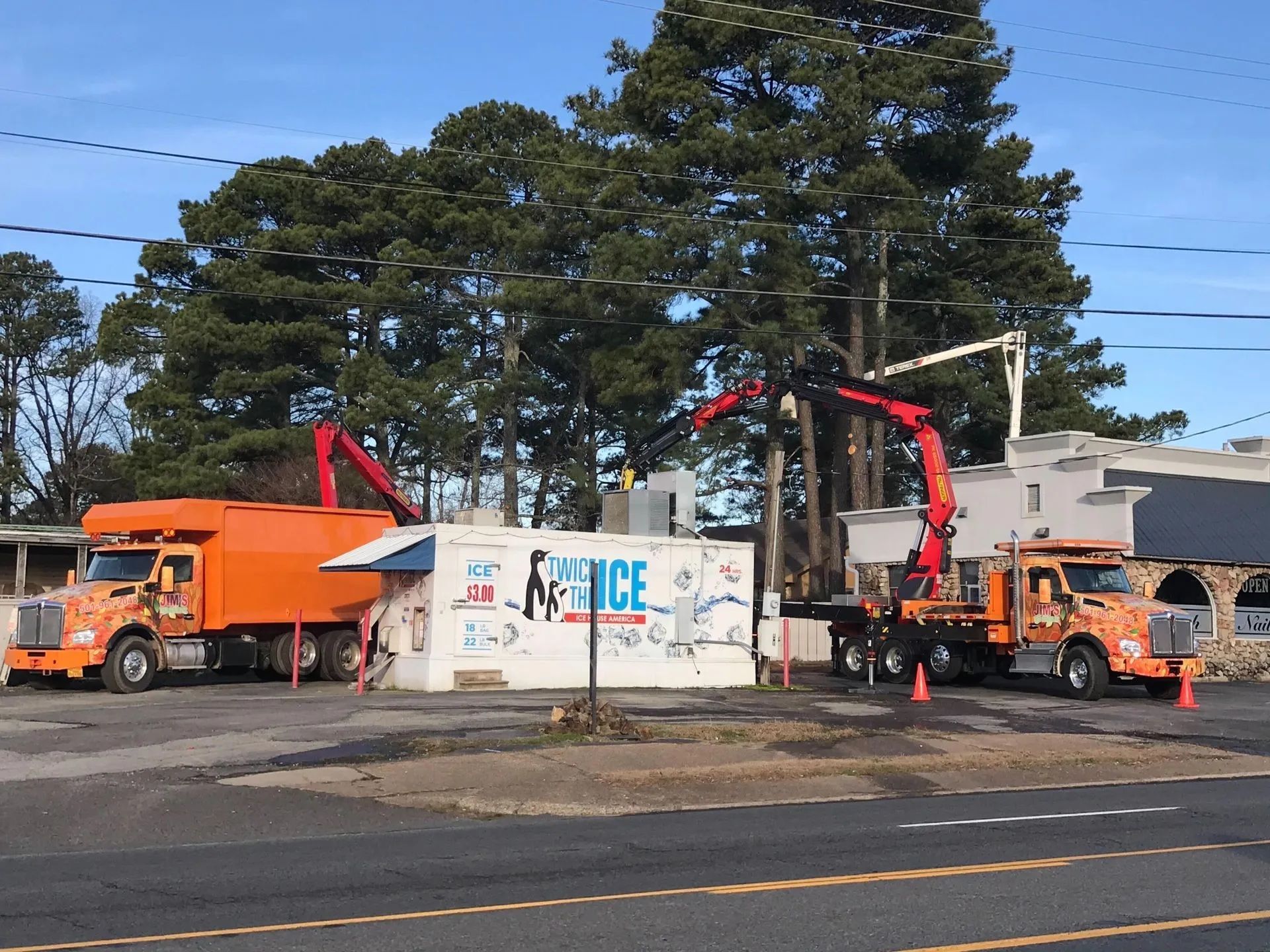 Two trucks are parked in front of a building that says prince ice