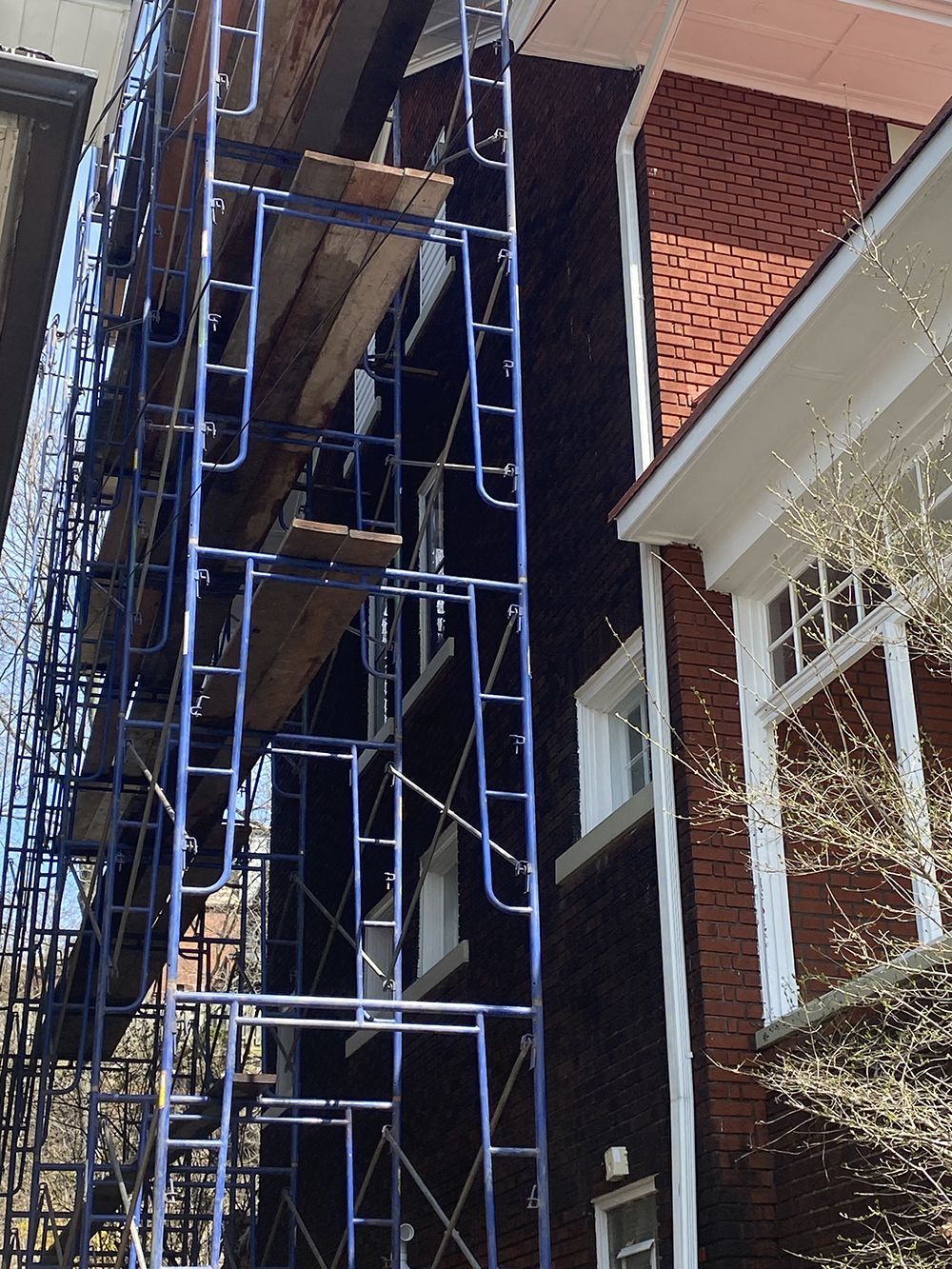 A brick building with scaffolding on the side of it