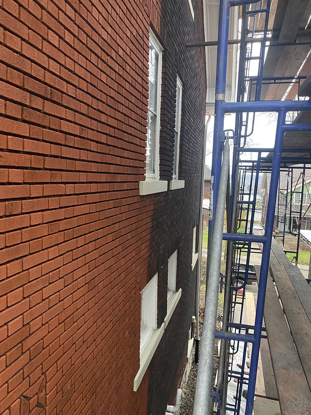 A brick building with scaffolding on the side of it.