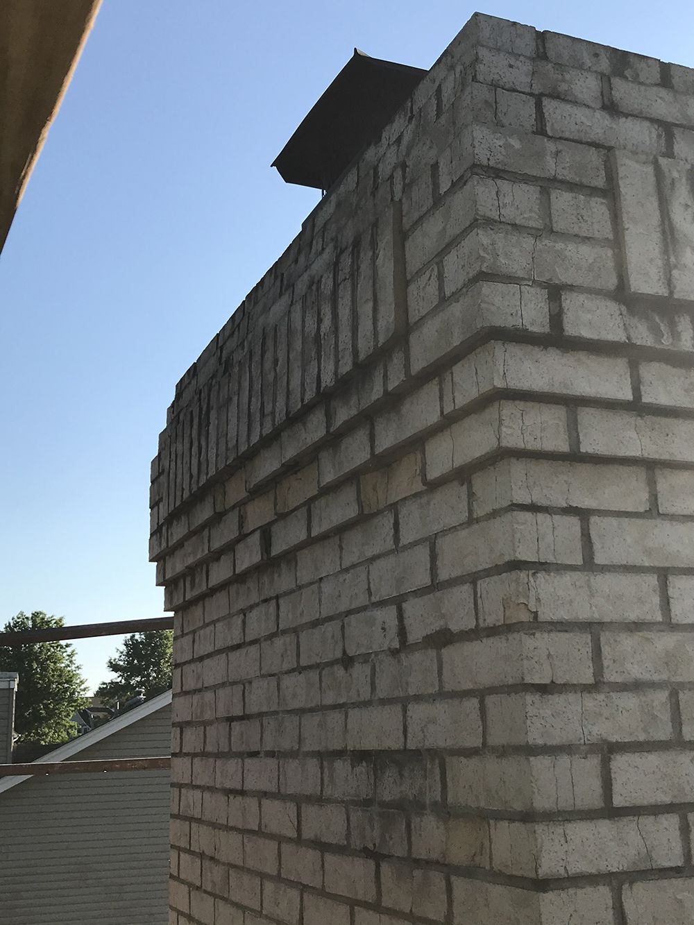 A brick wall with a chimney on top of it