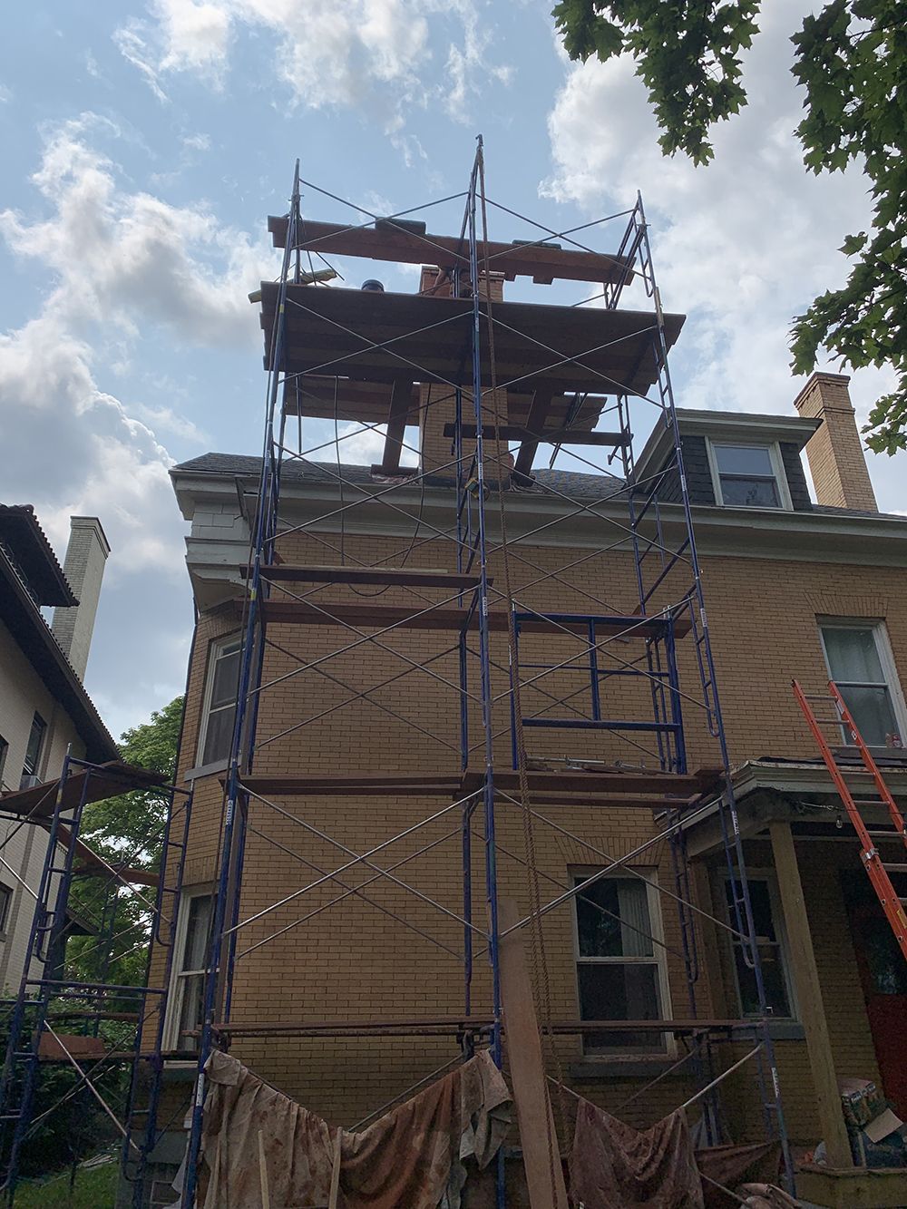 A house with scaffolding on the side of it.