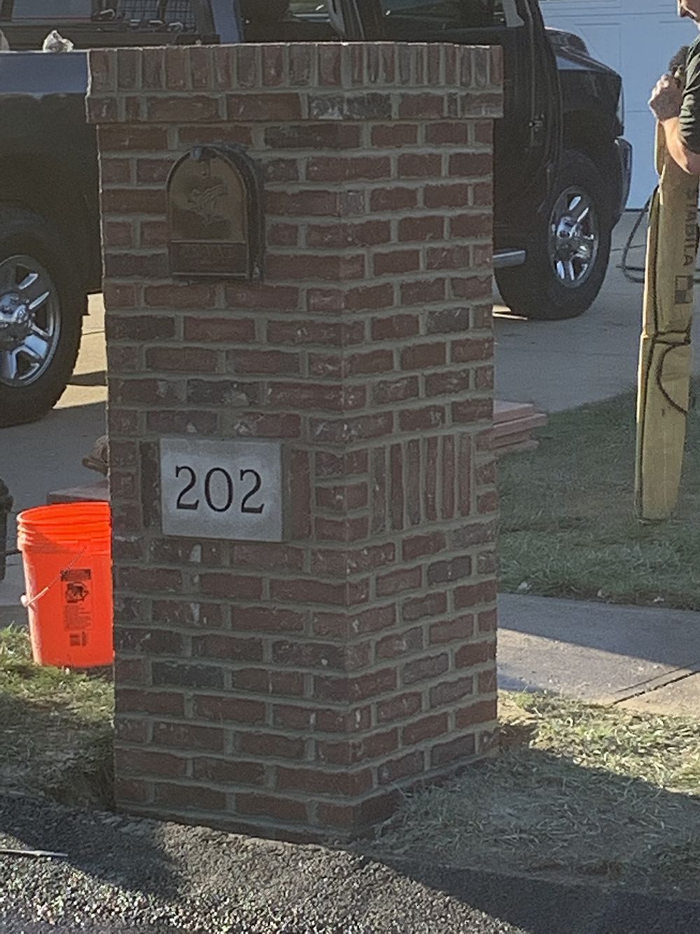 A brick mailbox with the number 202 on it
