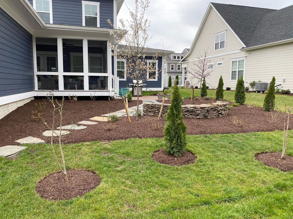 A house with a lush green lawn in front of it
