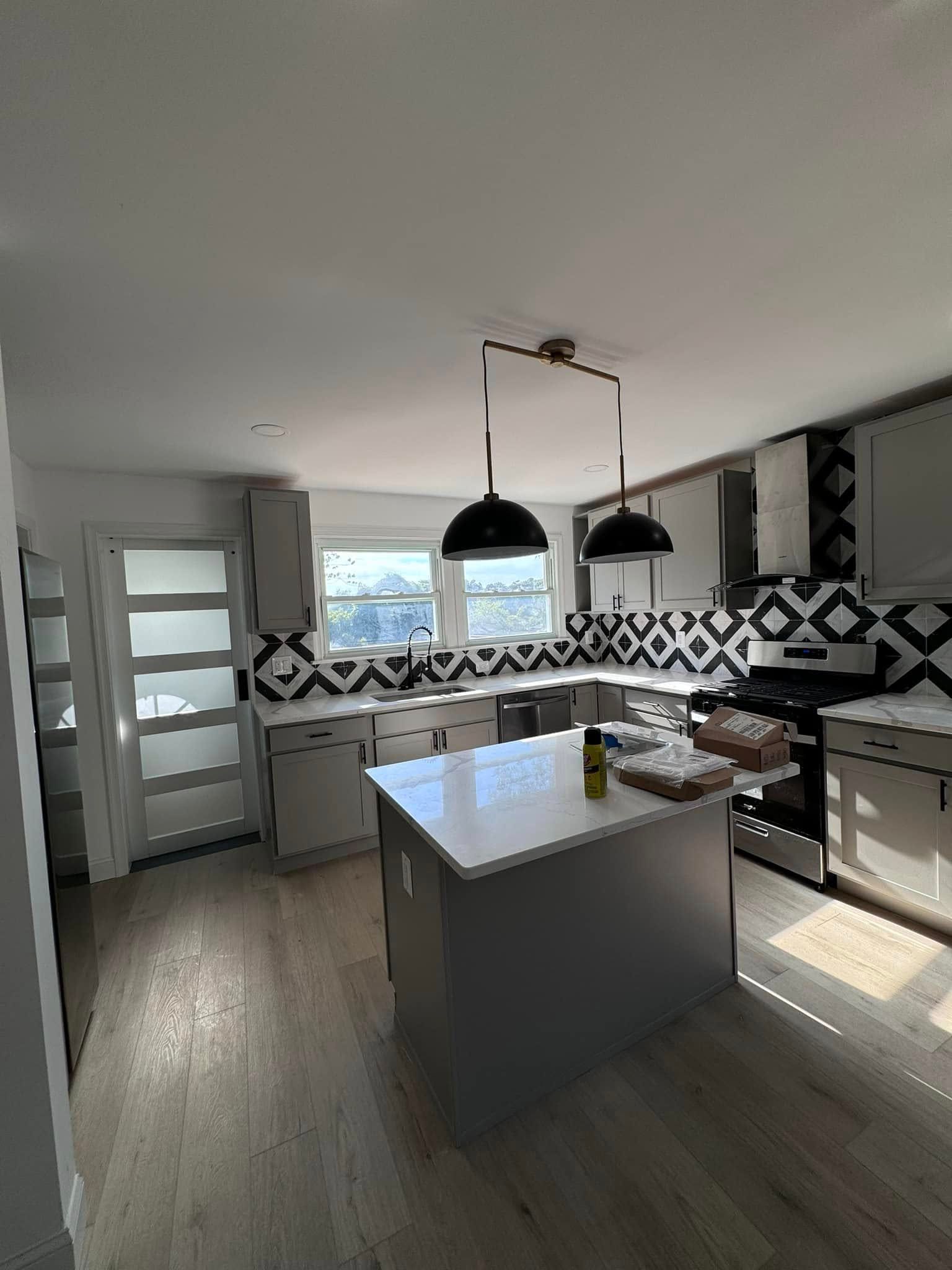 A kitchen with a large island in the middle of it.