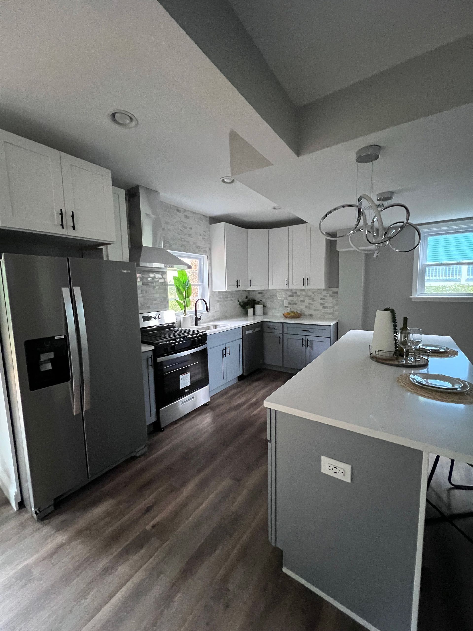 A kitchen with stainless steel appliances and white cabinets
