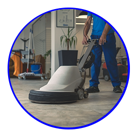 A man is cleaning a concrete floor with a machine
