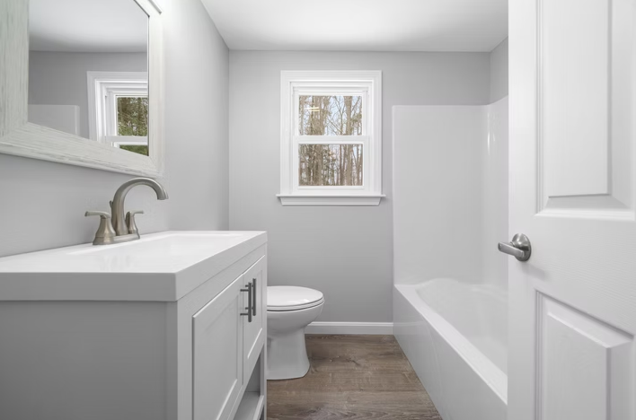 A bathroom with a sink, toilet, and bathtub.