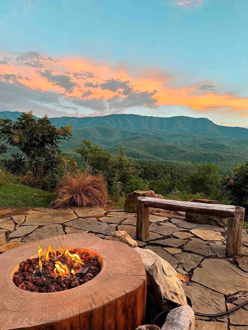 There is a fire pit with a view of the mountains in the background.