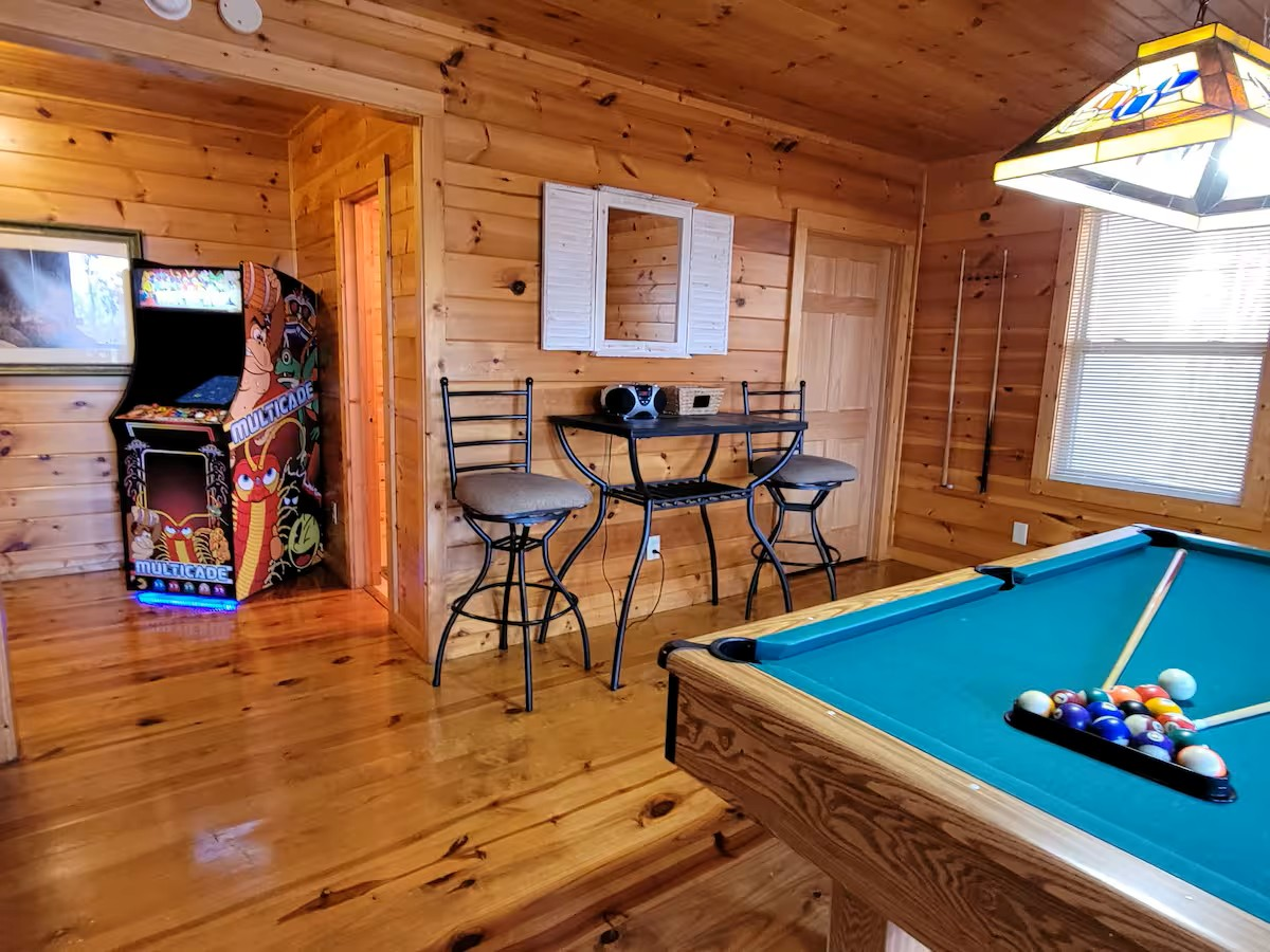 There is a pool table in the middle of the room.