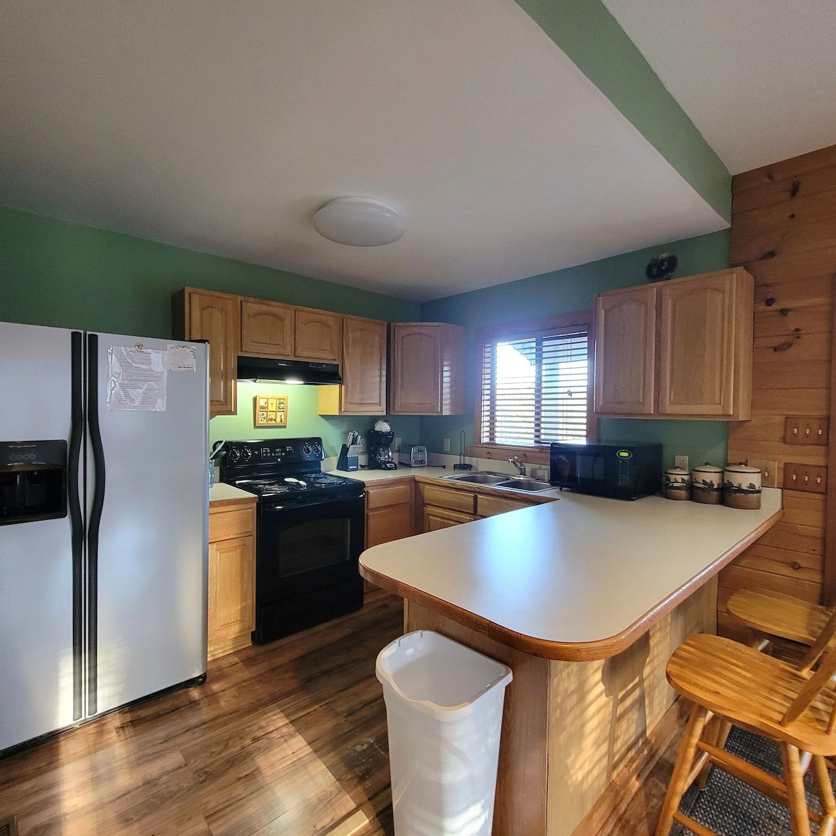 A kitchen with a refrigerator stove and sink