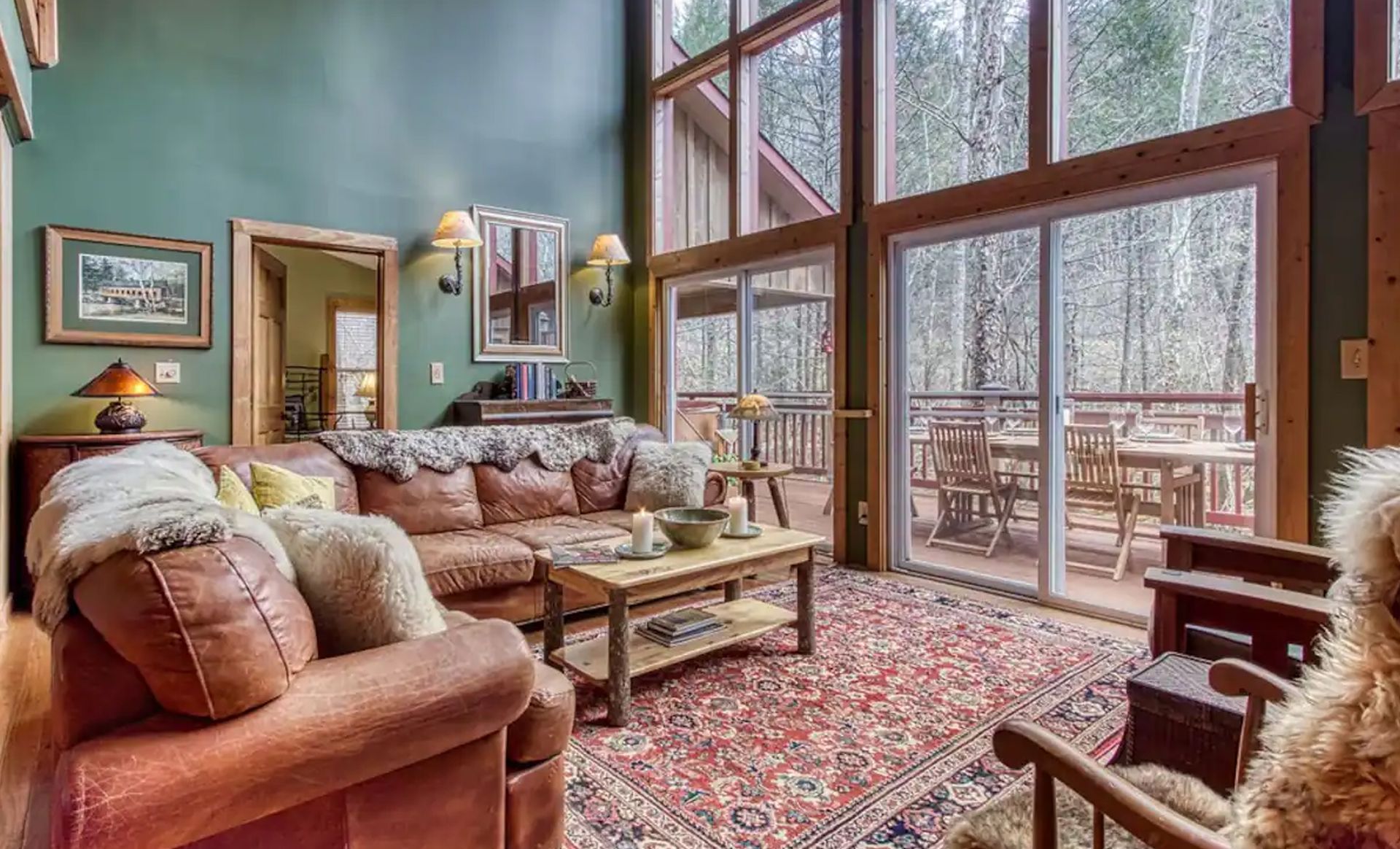 A living room with a couch , chair , coffee table and sliding glass doors.