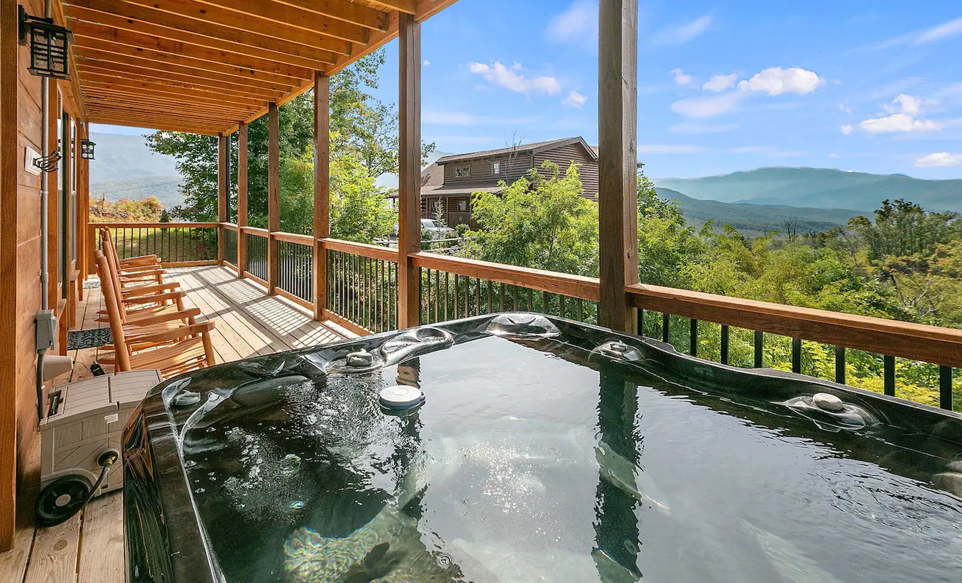 A hot tub on a deck with a view of the mountains.