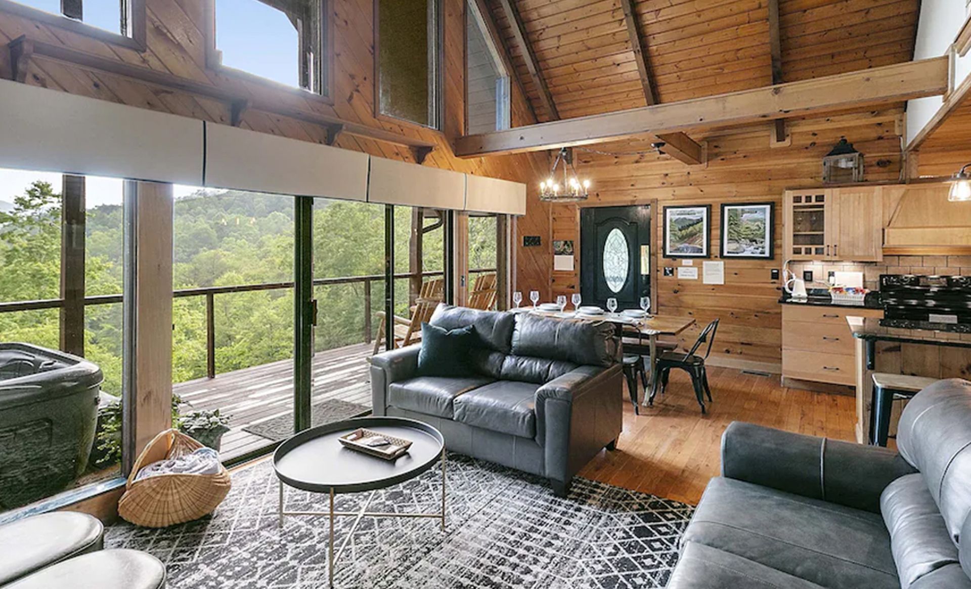 A living room in a log cabin with a couch and a table.