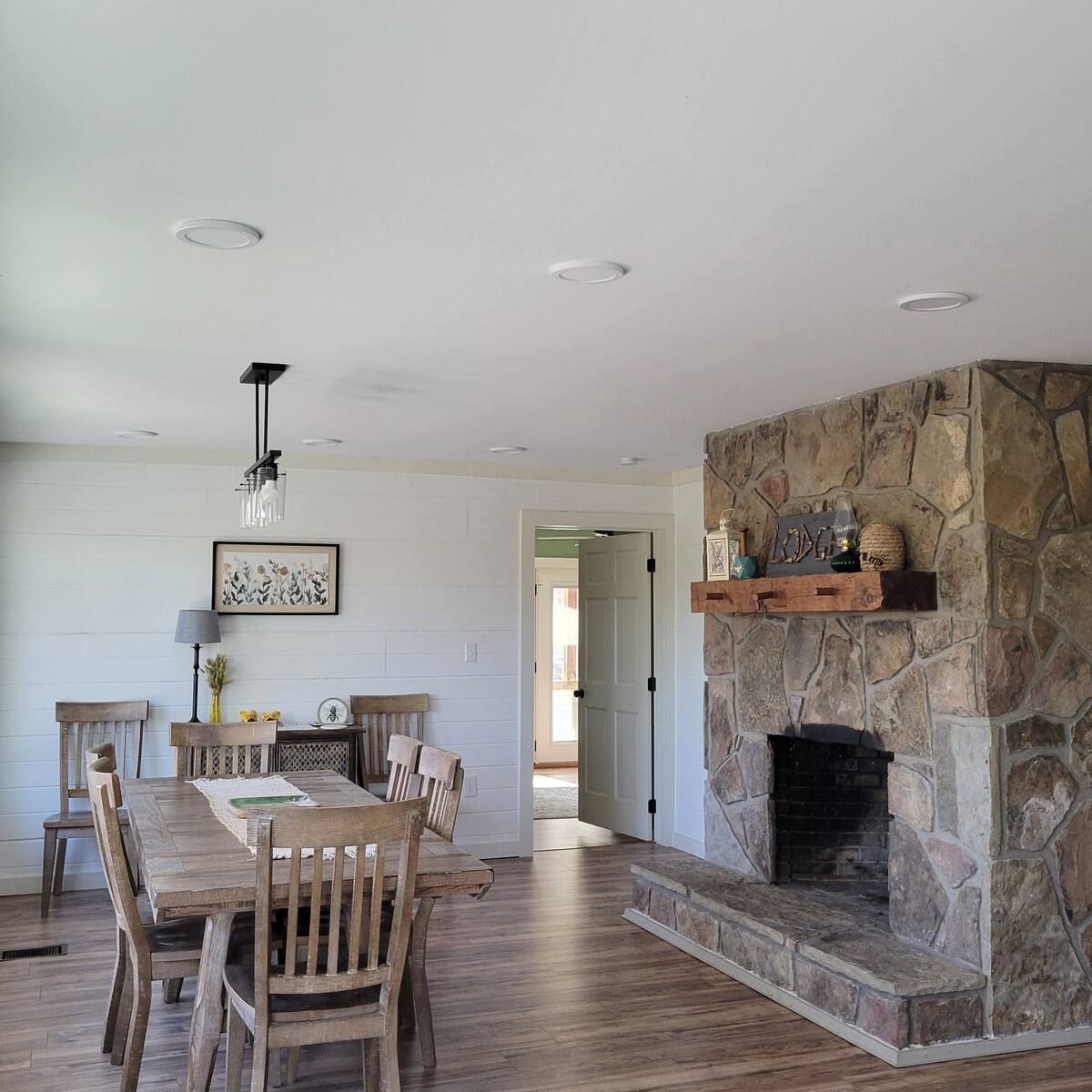 A dining room with a table and chairs and a fireplace