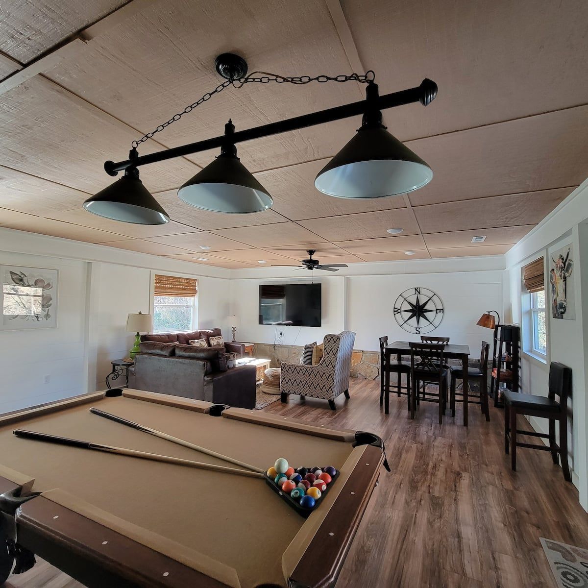 A pool table is in the middle of a living room