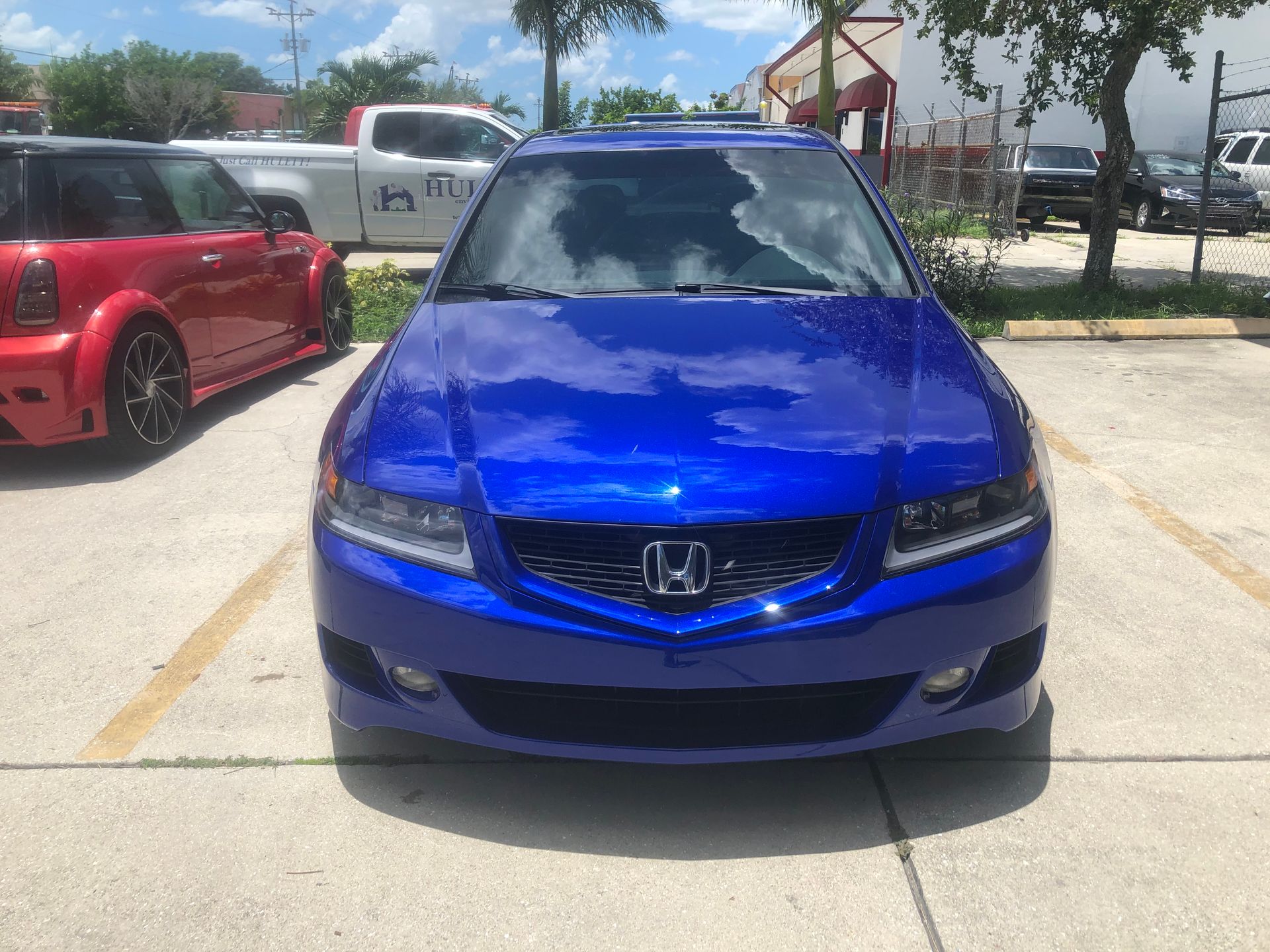 A blue honda accord is parked in a parking lot.