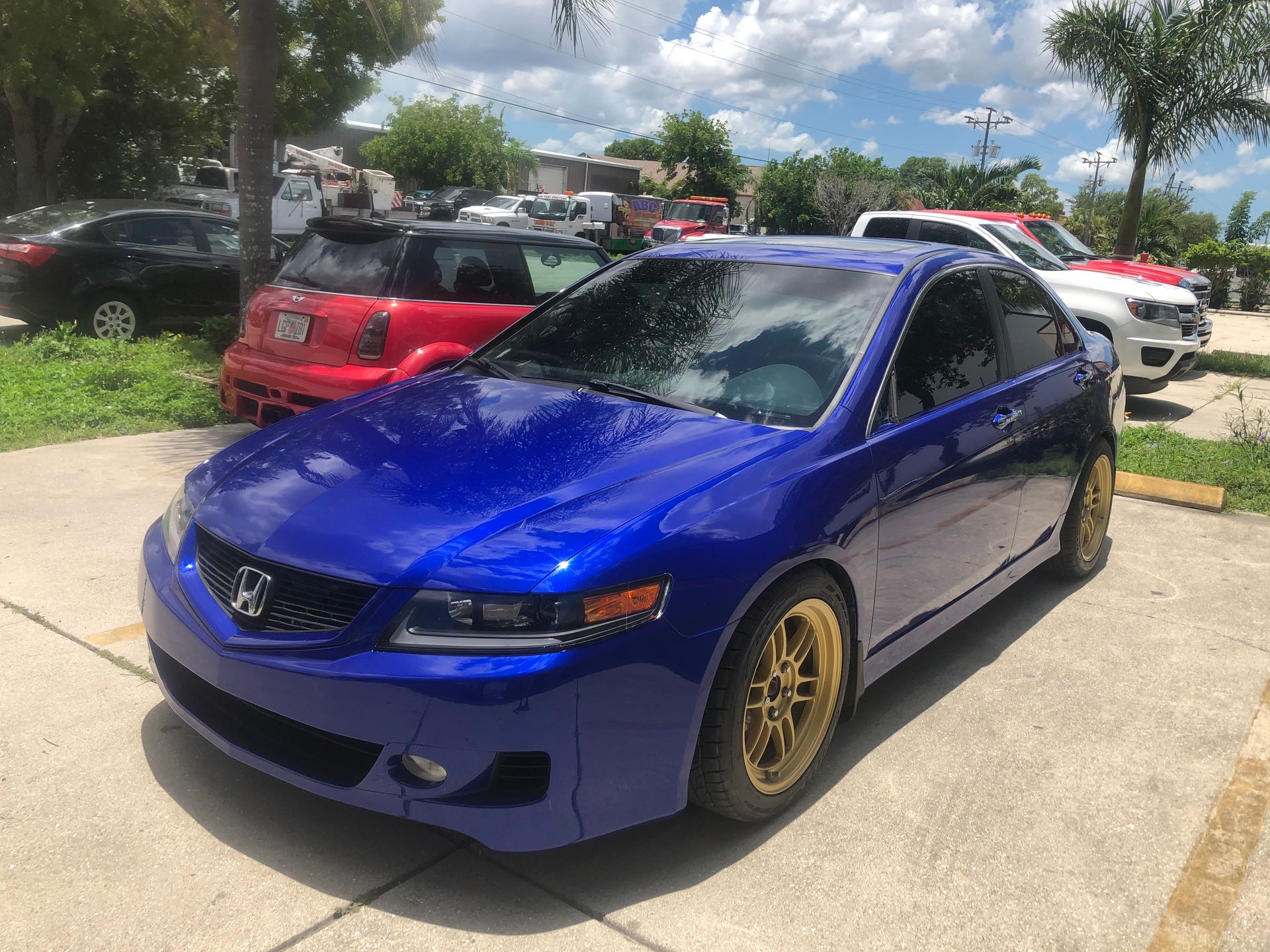 A blue honda accord is parked in a parking lot.
