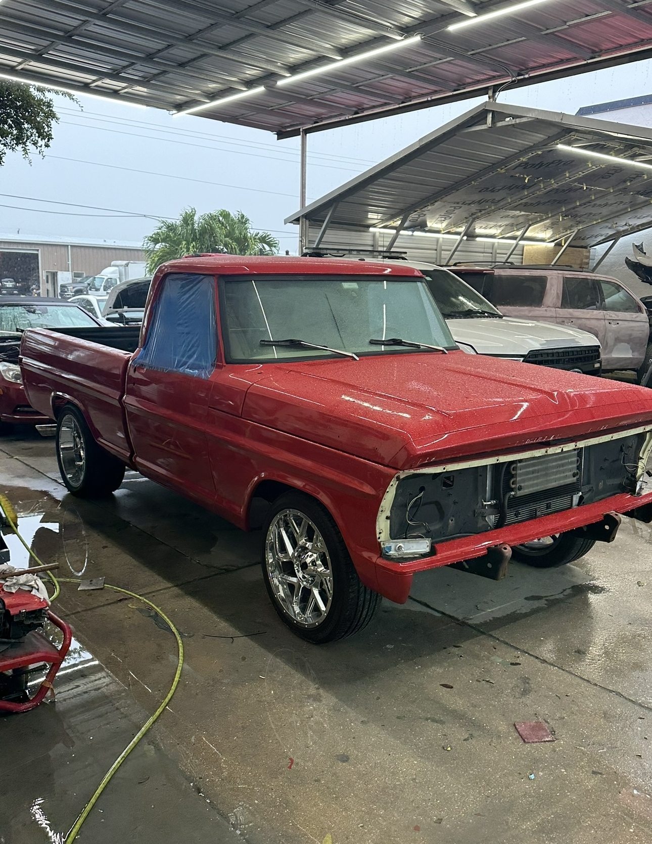 A red pickup truck is parked in a parking lot.