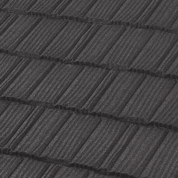 Close-up of a dark gray, textured metal roof with a staggered cedar shake-style pattern.
