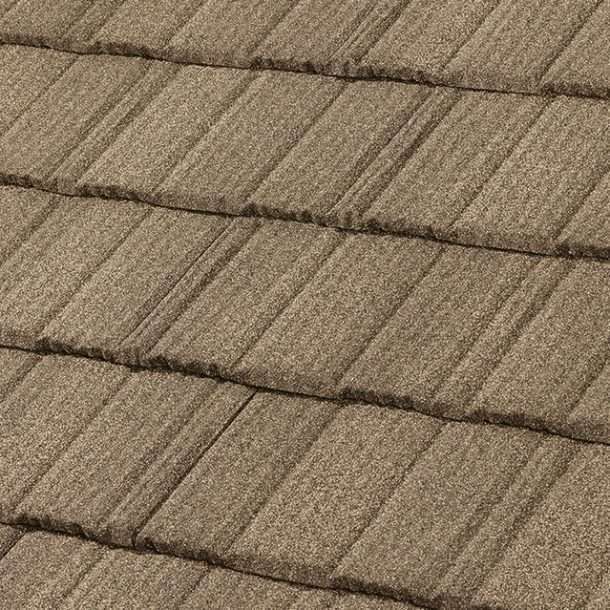 A close-up view of textured, brown stone-coated metal roof tiles arranged in a staggered, overlapping pattern.