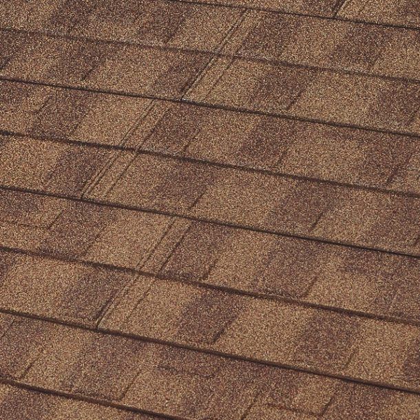 A pattern of brown architectural asphalt roof shingles with layered, rectangular textures.