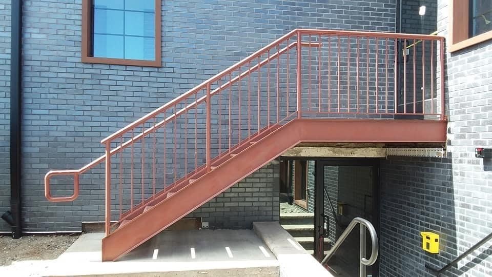 A set of stairs leading up to a brick building