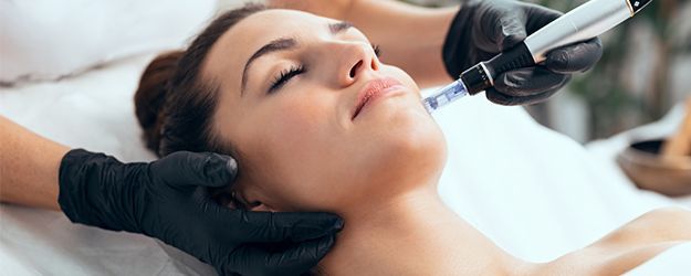 A woman is getting a facial treatment at a spa.