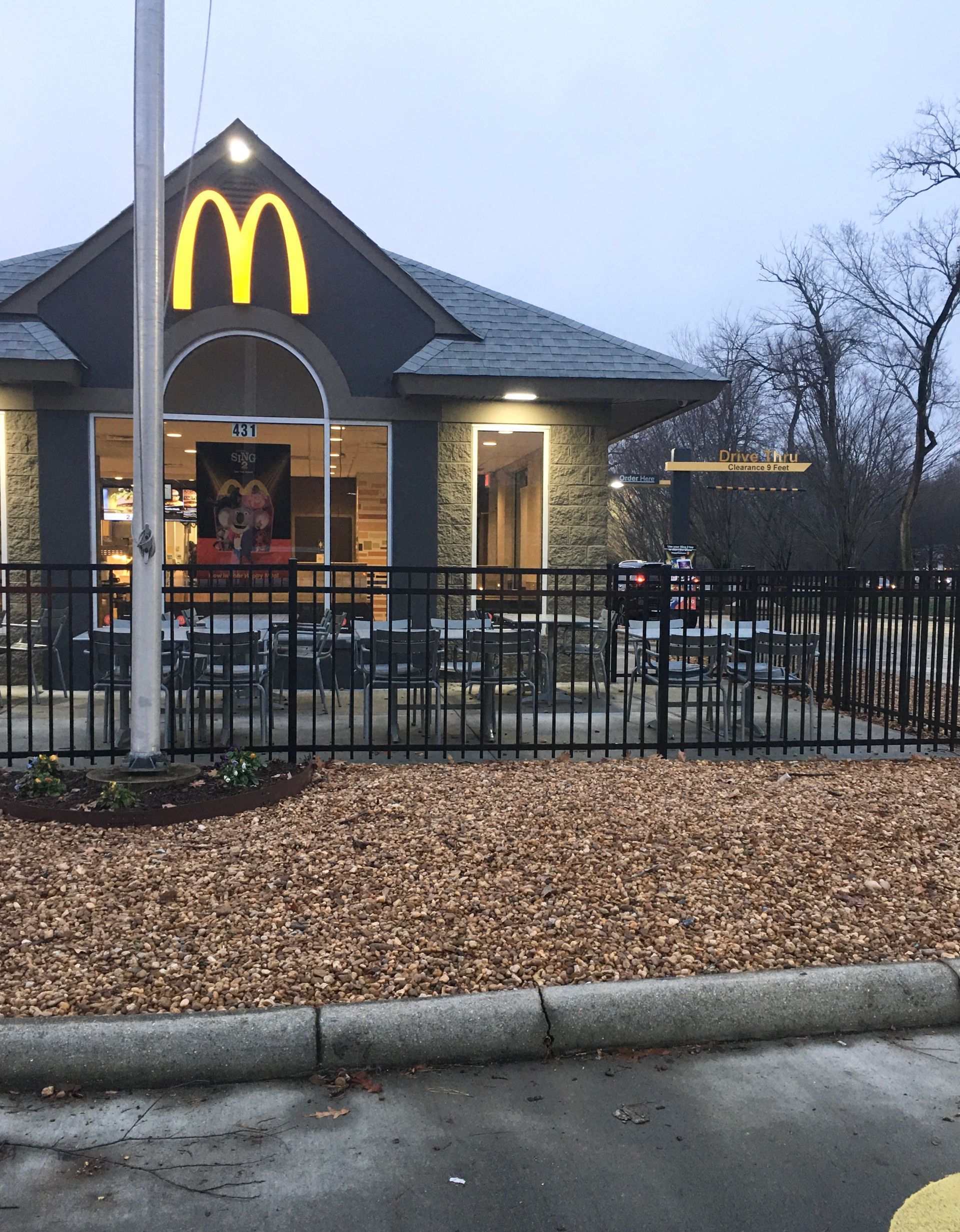 A mcdonald 's restaurant with a fence around it