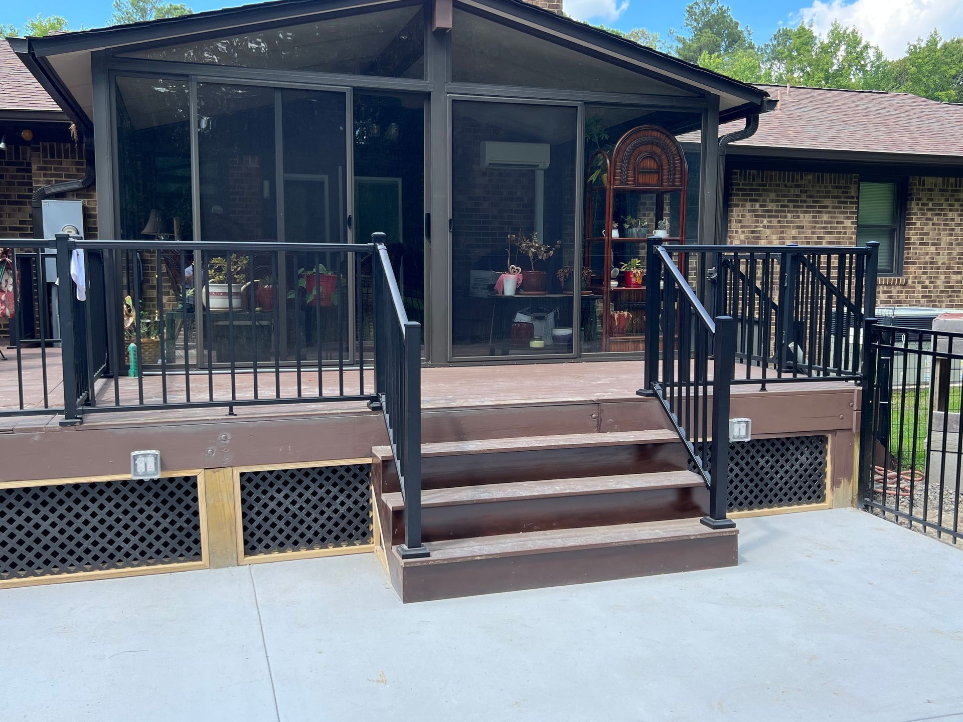 A house with a screened in porch and stairs