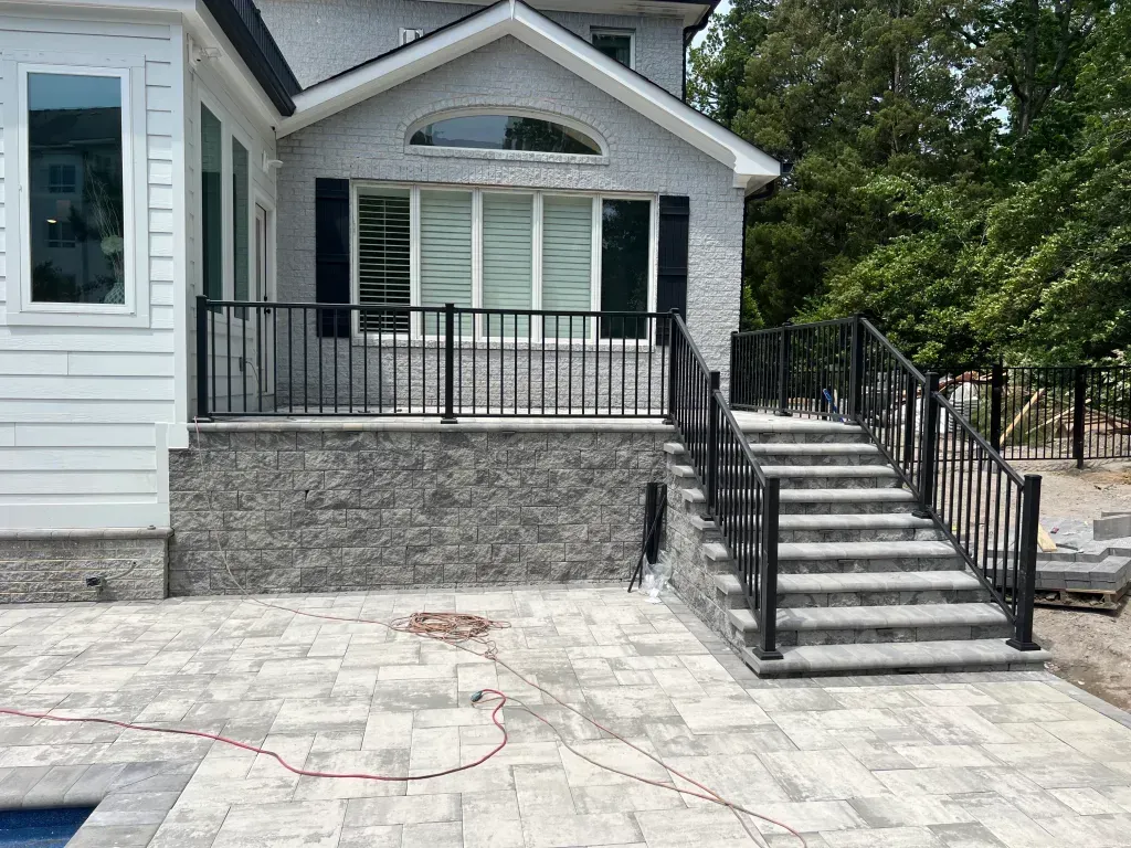A house with a patio and stairs leading up to it.