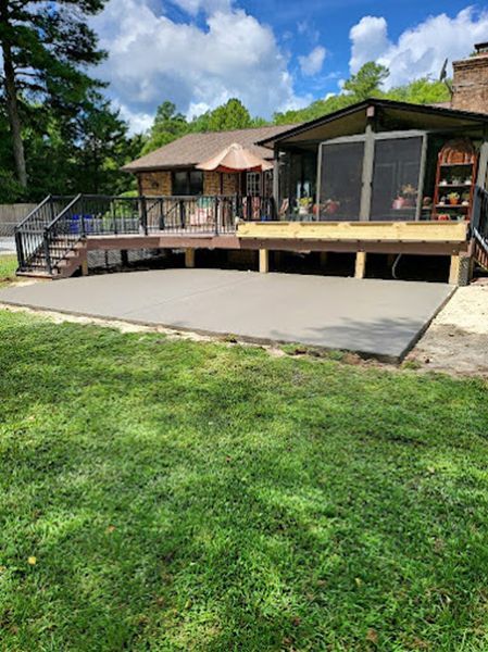 A house with a large deck and a screened in porch.