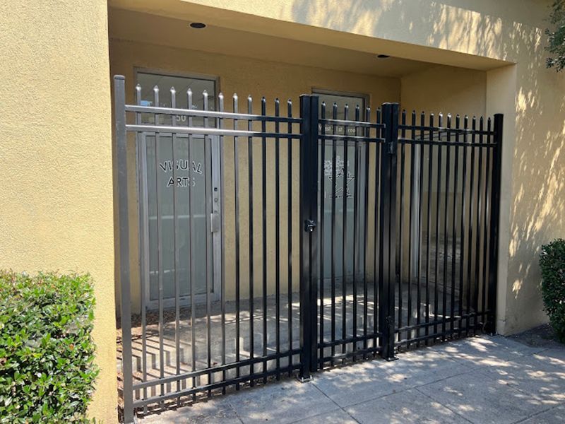 A black fence is sitting in front of a building.