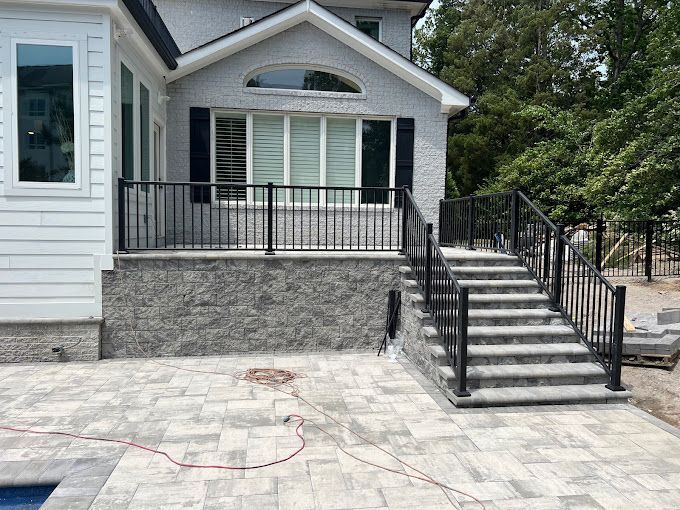 A house with a patio and stairs leading up to it.