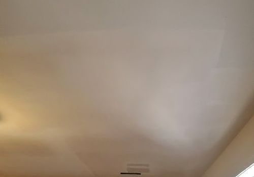 Ceiling with warm light and a small vent near the center