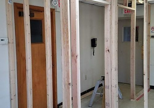 Exposed wooden framing and unfinished interior walls in a building under construction